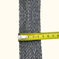 A tape measure on a piece of grey twill tape